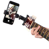 A hand holds a guitar with a 360° rotating phone mount attached for live streaming or recording.
