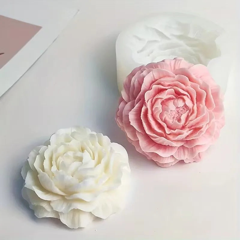 Two silicone molds shaped like pink and white peonies for baking, soap making, or crafting.