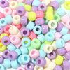 A close-up view of a 100-pack of colorful rainbow pony beads in various pastel shades and shapes.
