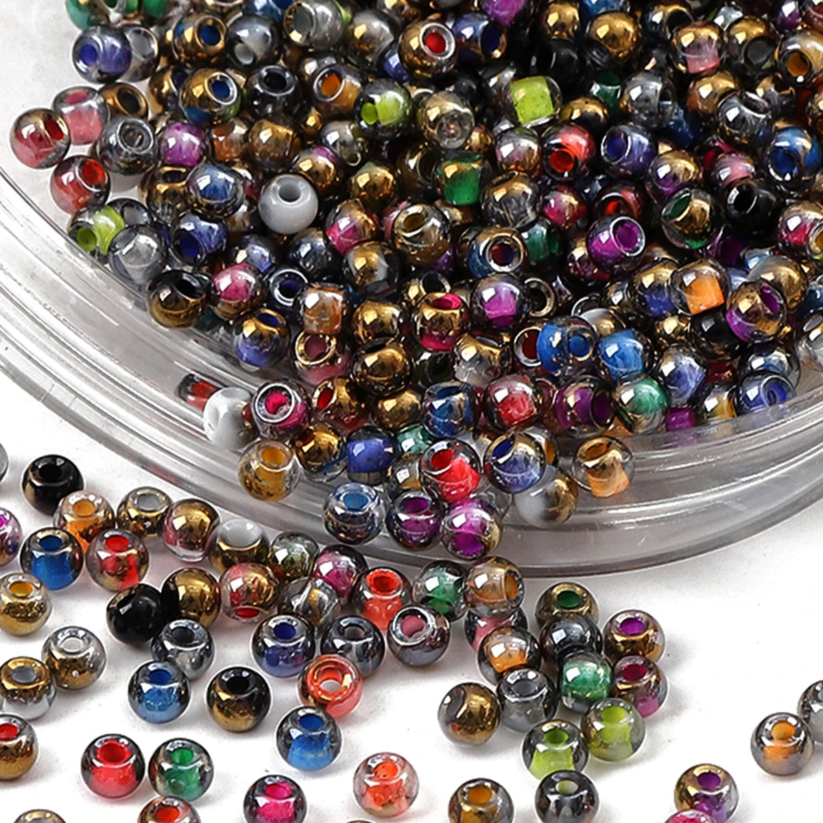 A pile of golden gradient glass beads for DIY jewelry making in a clear container.
