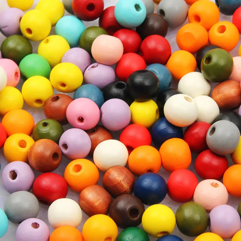 A colorful assortment of natural wooden beads in various shades including yellow, red, green, and purple.
