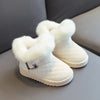 Pair of white snow boots with plush white faux fur lining and a crystal bowknot detail