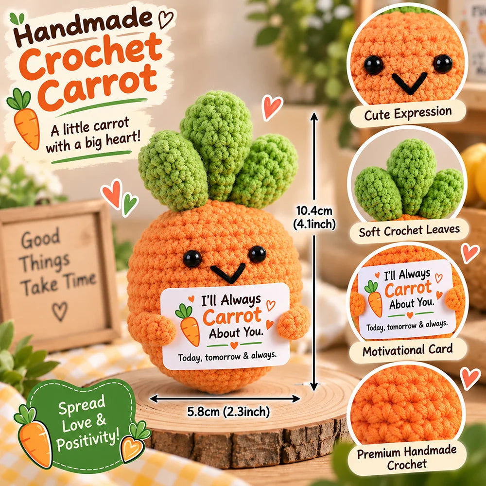 Handmade crochet carrot doll with a motivational card sitting on a wooden surface.