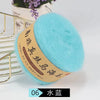 A ball of light blue fuzzy yarn labeled South African Comatose Hair for knitting projects