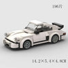 A white classic rally car model built from building blocks, shown in a side view.