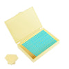 A yellow diamond painting storage organizer box is open, revealing a tray filled with small blue beads.