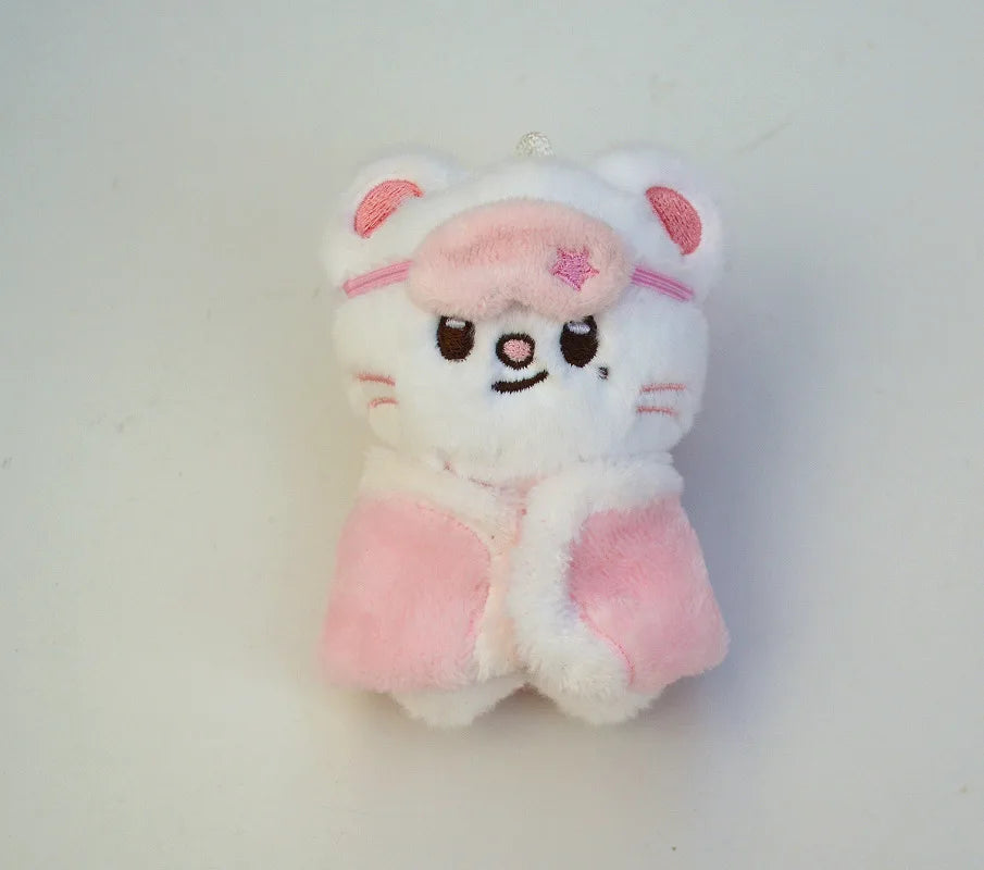 A white and pink cartoon animal plush keychain with large ears and a pink bow.