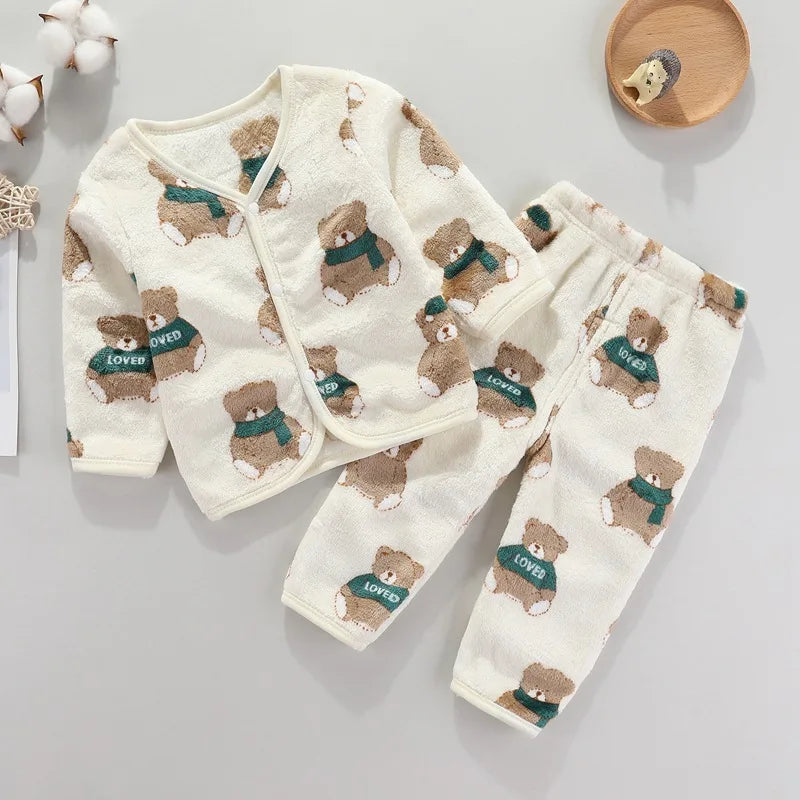 A cream-colored fleece jacket and pants set for a baby featuring cartoon bear prints in brown and green.