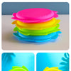 A stack of colorful silicone splash flying rings in pink, yellow, green, and blue.