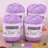 Four skeins of purple cotton knitting yarn for crochet and handmade projects