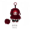 A collectible figure of a small, red-haired creature with fluffy red fur and black accents, suspended by a loop.