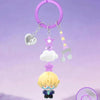 A purple necklace with charms hangs above a figure of an anime character.