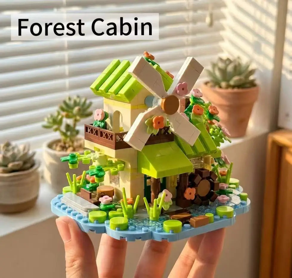 A miniature forest cabin building block set featuring a house, greenhouse, and windmill built on a blue base.