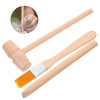 A set of tools for a dinosaur excavation kit including a wooden hammer, chisel, and brush.