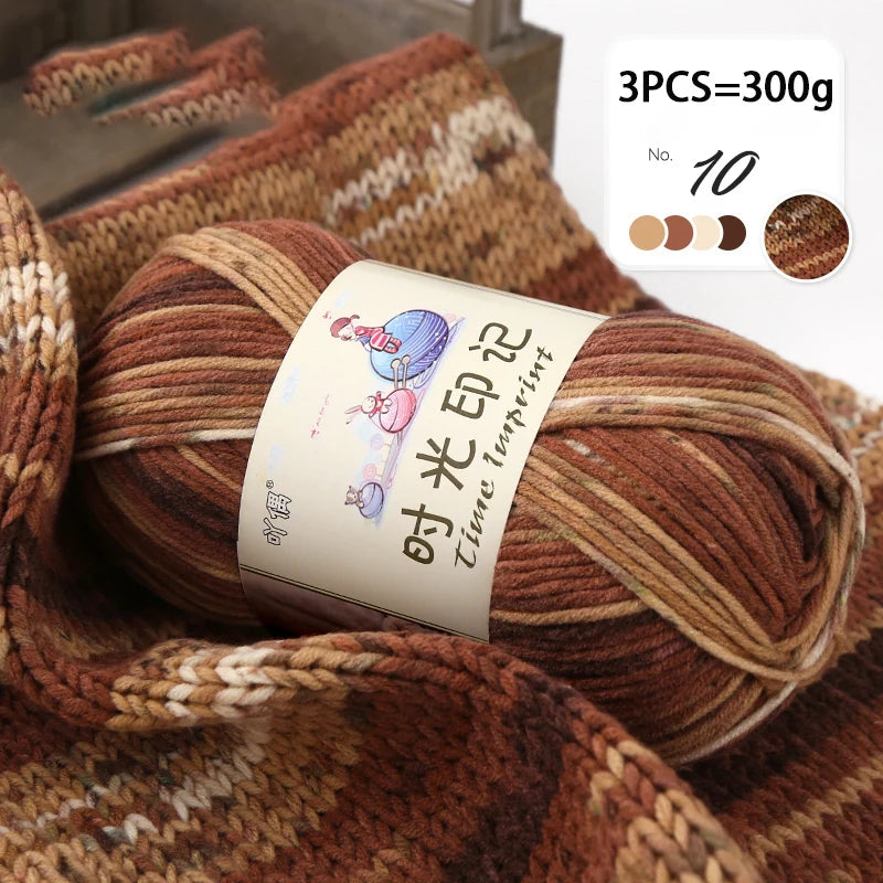 A close-up of three skeins of brown gradient acrylic yarn used for knitting or crochet.