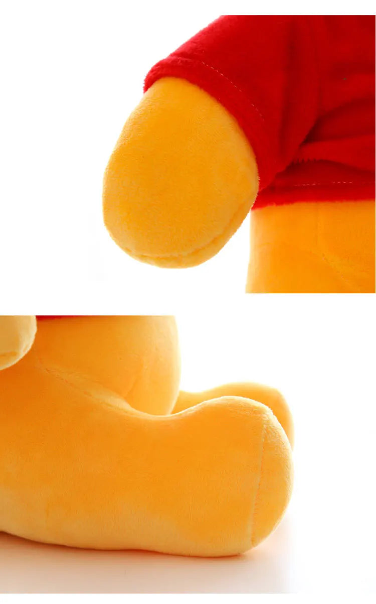Close-up of a yellow plush donkey figurine with red fabric details.