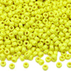 A pile of small yellow pony beads for jewelry, braids, and crafts.