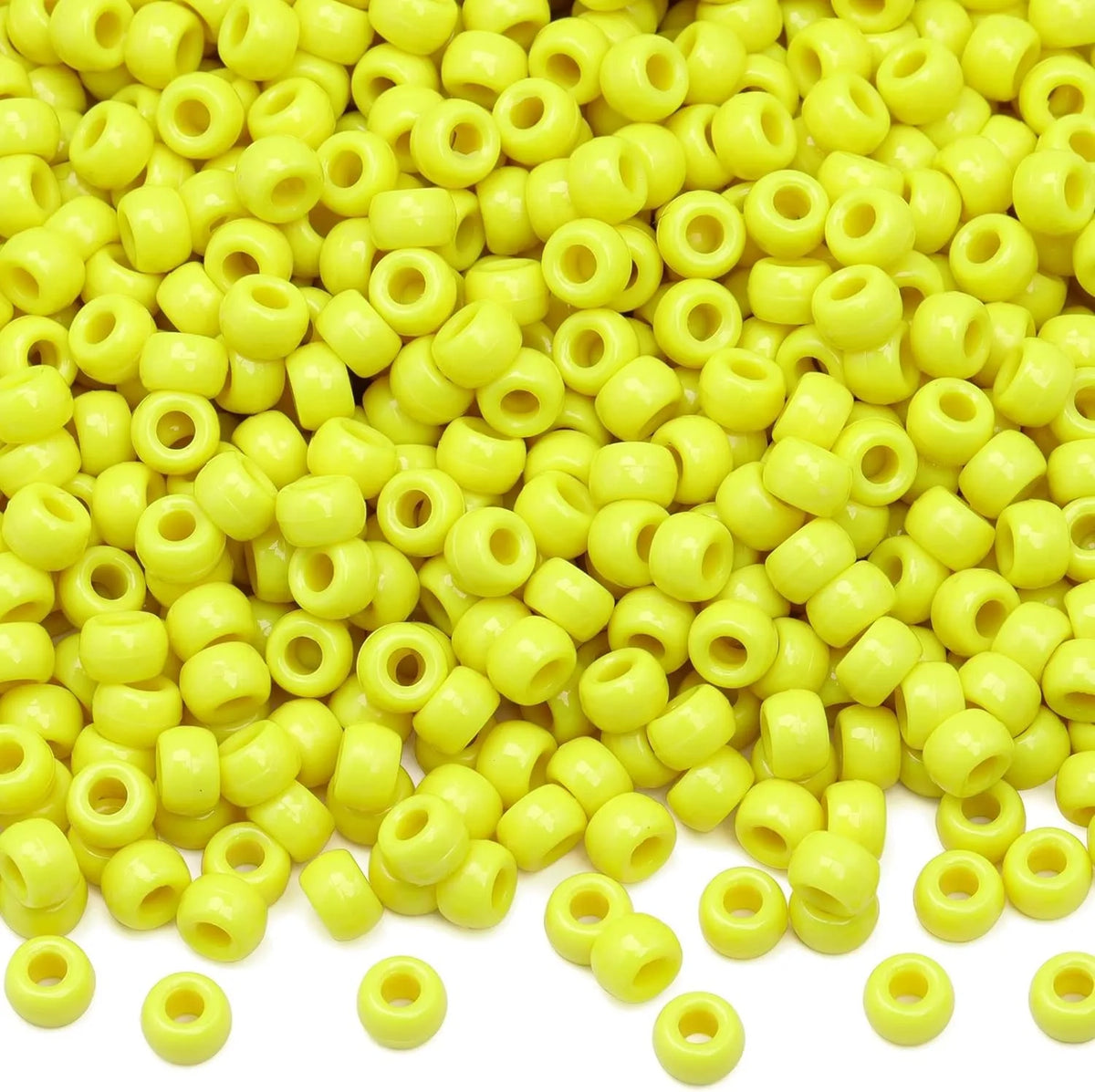 A pile of small yellow pony beads for jewelry, braids, and crafts.