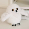 A fluffy white cartoon bird plush with black accents, used as a keychain or pendant.