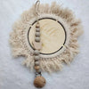 A personalized wooden baby pacifier clip featuring silicone beads and a natural fiber wreath.