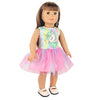 A doll wearing a unicorn themed outfit consisting of a multicolored top and a pink tulle skirt.