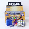 A box of Roblox Series 2 Collect Them All figures and building blocks, including a blue cube and various minifigures.
