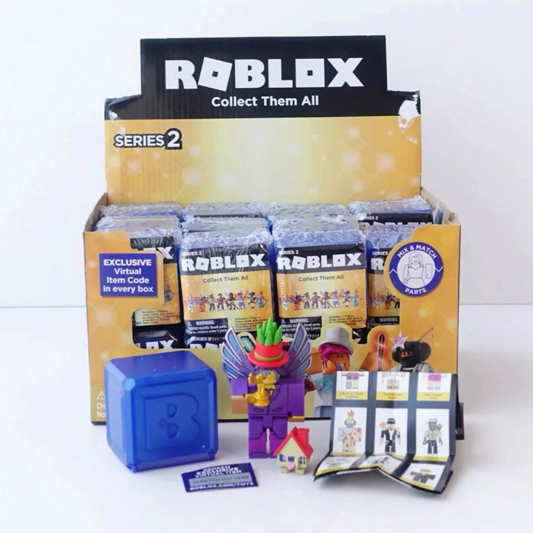 A box of Roblox Series 2 Collect Them All figures and building blocks, including a blue cube and various minifigures.