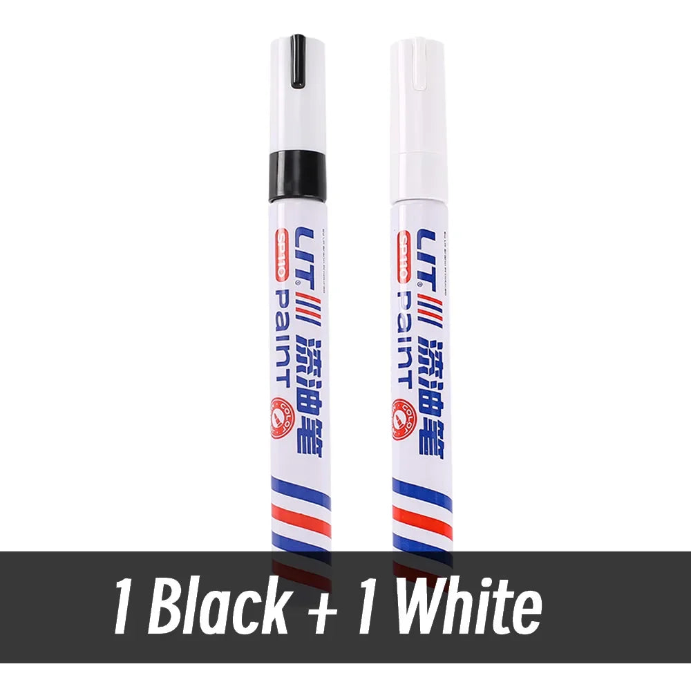 Two permanent paint markers, one black and one white, standing upright.