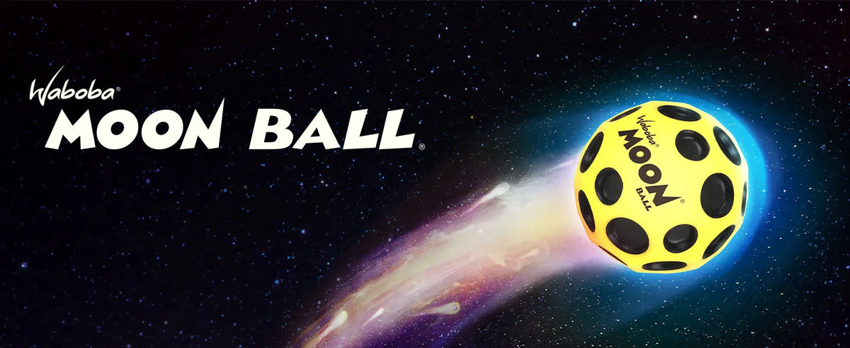 A yellow moon ball is shown against a dark, starry background with a bright purple and blue streak behind it.