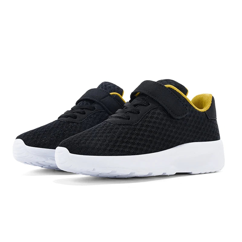 A pair of black and yellow breathable mesh kids' sneakers with hook-and-loop closure shown from the side.