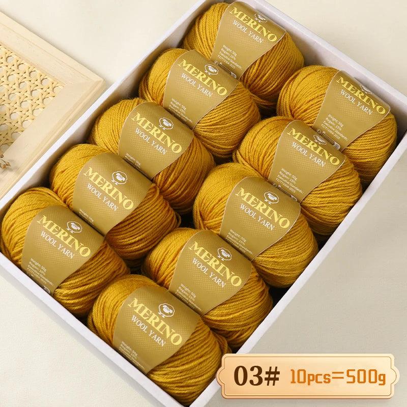 A box filled with ten balls of yellow merino wool yarn labeled Merino Wool Yarn