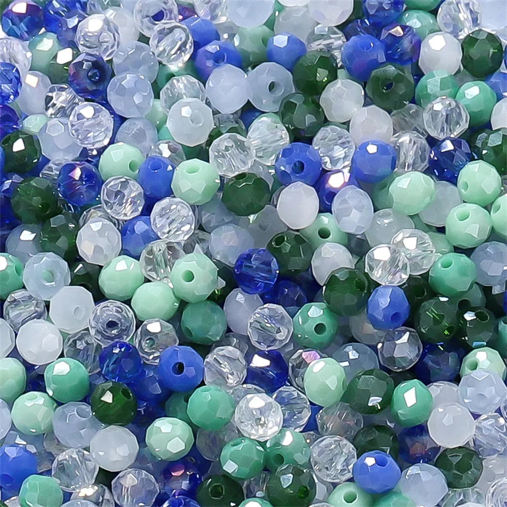 Mixed color faceted rondelle glass beads in shades of blue, green, and white for jewelry making