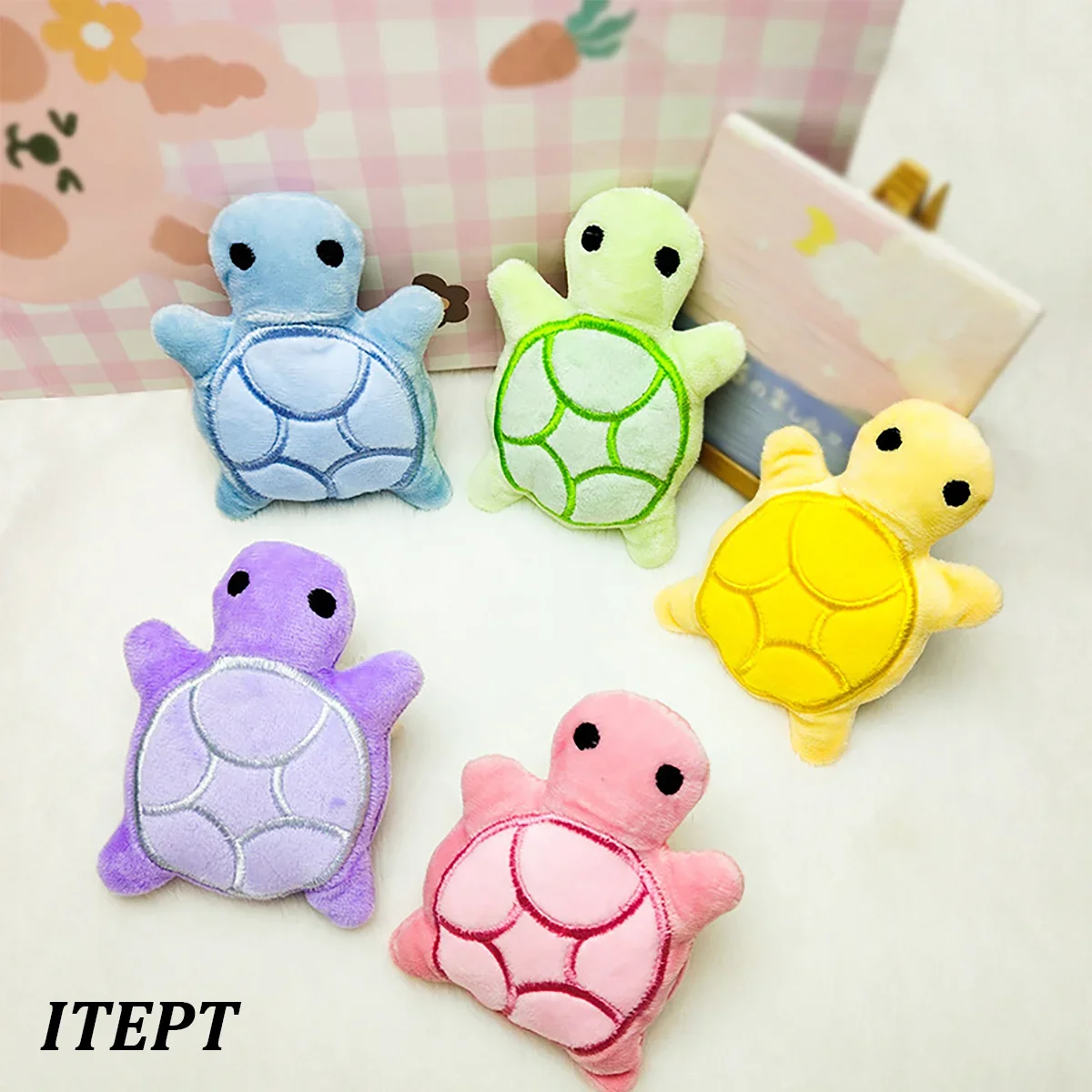 A collection of colorful mini turtle plush toys in blue, lime green, yellow, and pink resting on a white surface.