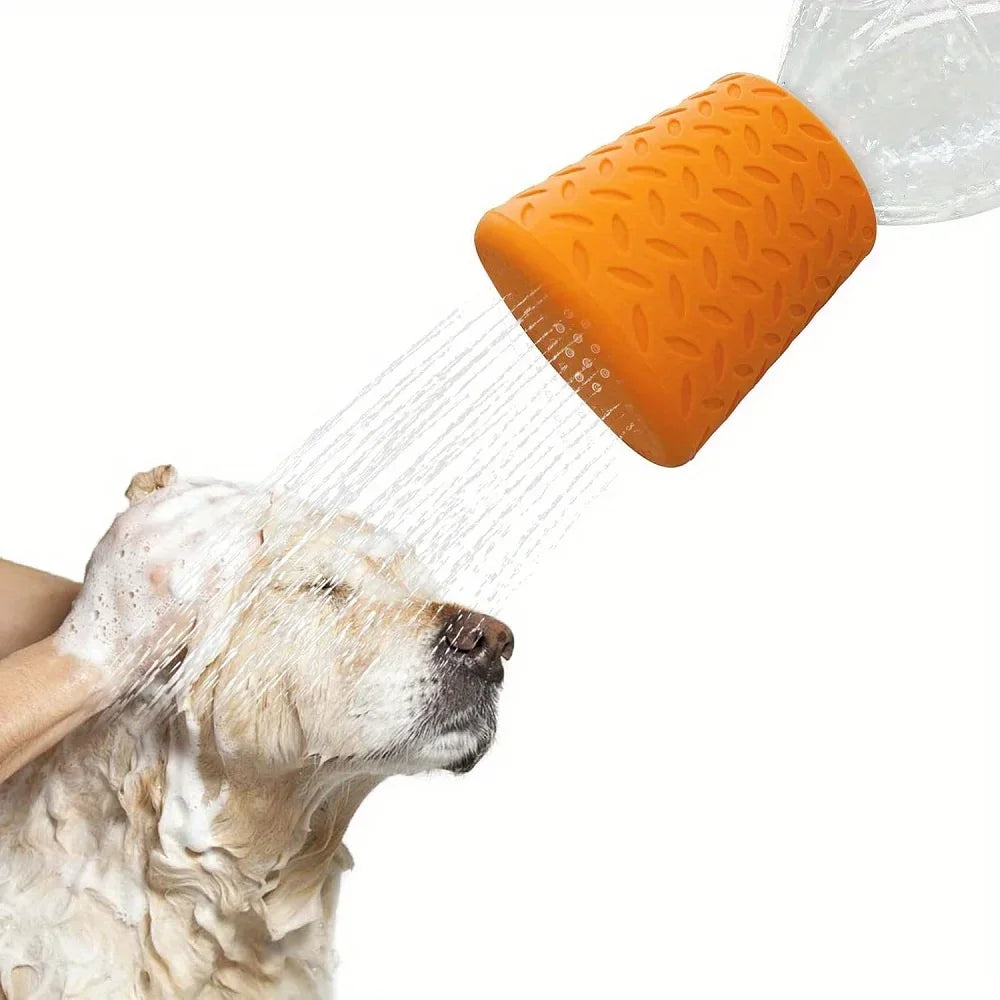 An orange silicone pet shower head is spraying water onto a dog's face.