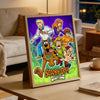 A framed jigsaw puzzle featuring characters from Scooby-Doo Mystery Inc. on a wooden background.