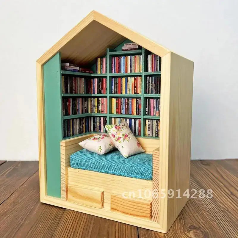 A wooden miniature bookshelf decor set with green shelving filled with colorful books and a blue mat inside.