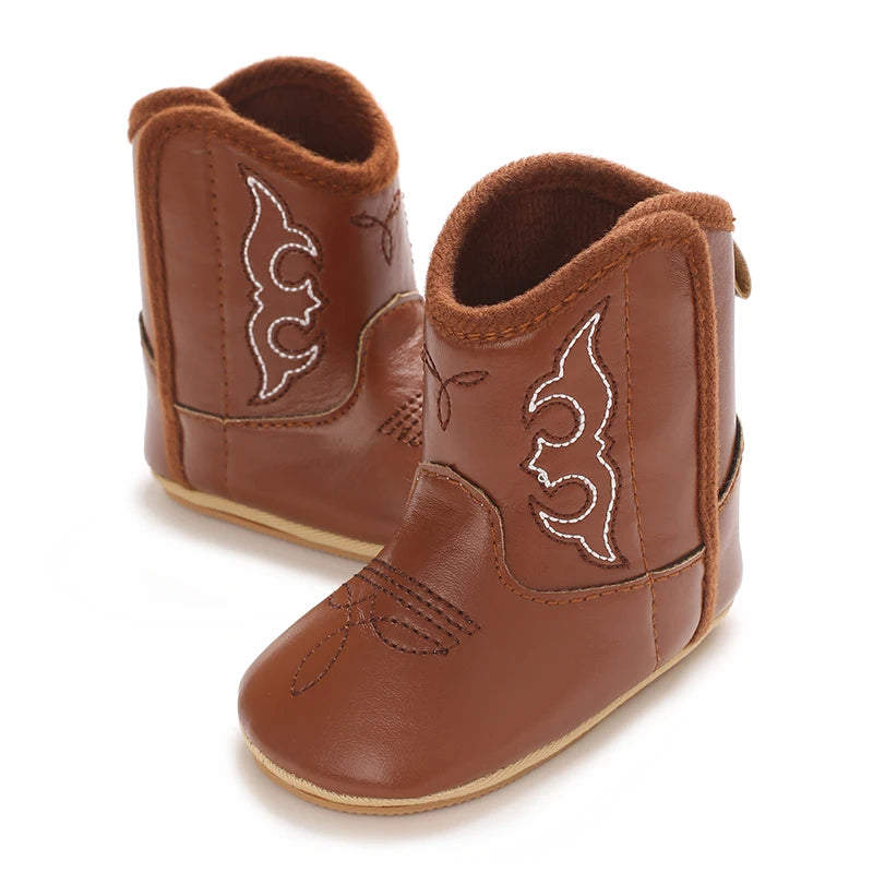 A pair of brown baby western booties with soft non-slip soles.