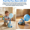 A child is playing with a blue balloon-powered racing car toy on a carpet.