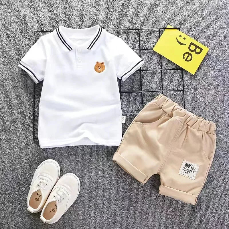 A set of a white short sleeve t-shirt and beige shorts for a boy