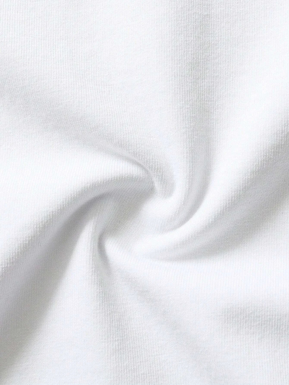 A close-up of a white cotton t-shirt with a subtle texture, folded in a soft swirl.
