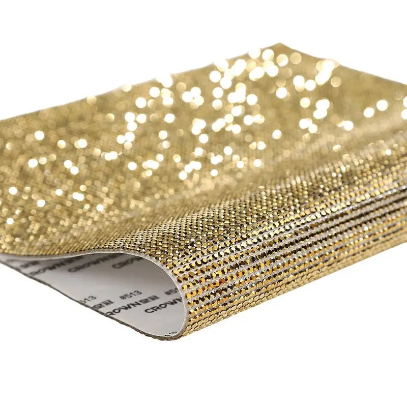 Gold sparkling rhinestone adhesive tape rolled up for DIY crafts and decor