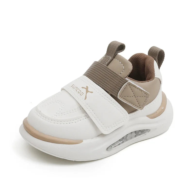 A pair of kids' everyday sneakers in white and beige with gray velcro straps.