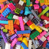 A close-up view of a large assortment of colorful plastic building blocks in various shapes and colors.