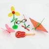Colorful 3D printing pen components including a flower, a beaded chain, and an orange leaf shape.