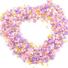 A heart-shaped arrangement of colorful polymer clay flower charms in pink, purple, and yellow.
