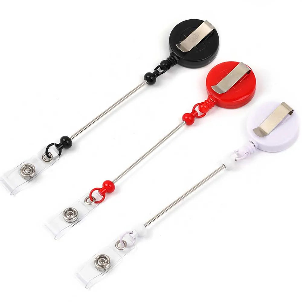 A set of beadable badge reels with retractable clips in black, red, and white.