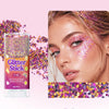 A tube of Sevich Glitter Stick in pink with purple and gold sparkles next to a model applying glitter makeup on her eye.