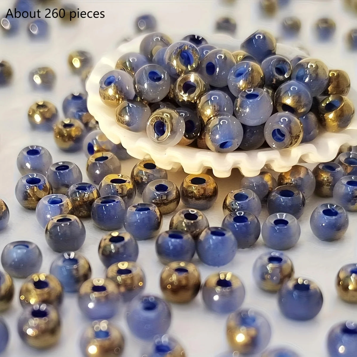 A pile of round, vibrant blue and gold beads for jewelry making