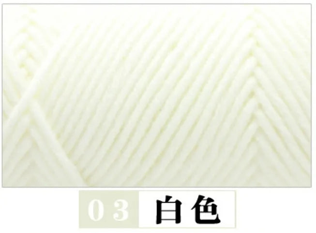 Close-up view of white premium milk cotton yarn for knitting, showing the twisted texture.
