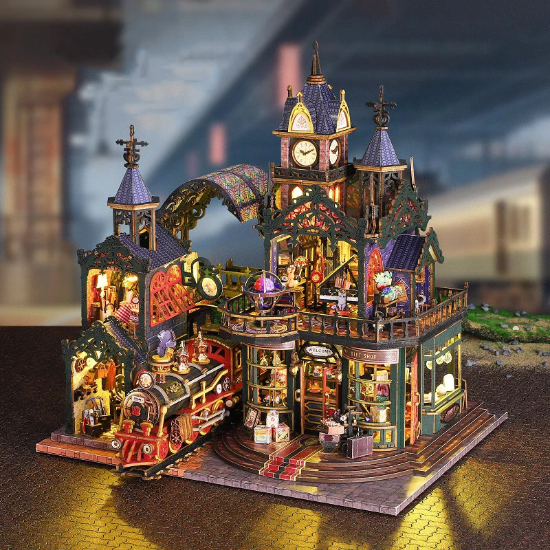 A detailed wooden miniature rail-track city dollhouse kit featuring buildings, figures, and furniture.